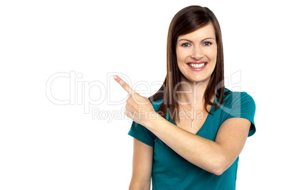 Attractive lady pointing towards copy space area