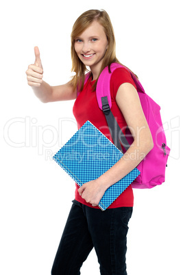 Pretty university student showing thumbs up sign