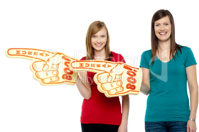 Cheerful fans pointing the big foam hand sideways