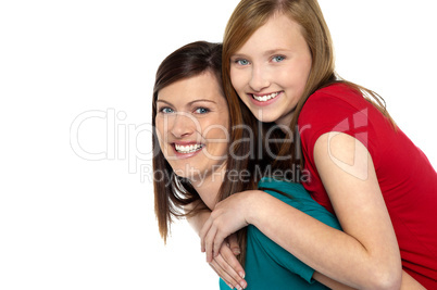 Mother giving daughter ride on back