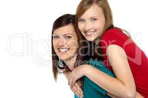 Mother giving daughter ride on back