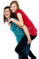 Happy mother giving piggyback ride to her daughter