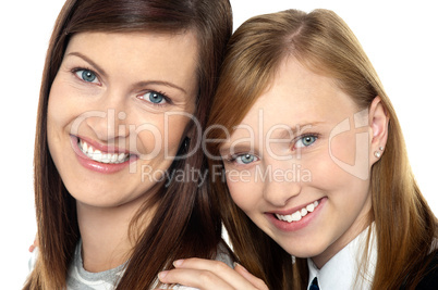Closeup of mom and daughter flashing a smile