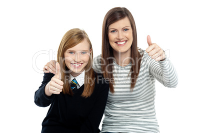 Charming daughter with her mother showing thumbs up sign