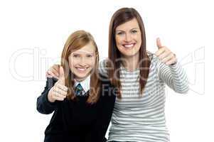 Charming daughter with her mother showing thumbs up sign