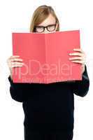 Student with a red book learning intently