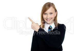 Calm and relaxed teen girl pointing sideways