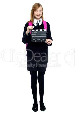 Cute school girl with a clapperboard