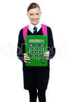 School girl holding large green calculator