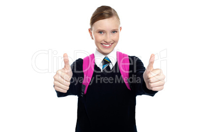 Bright student showing thumbs up sign