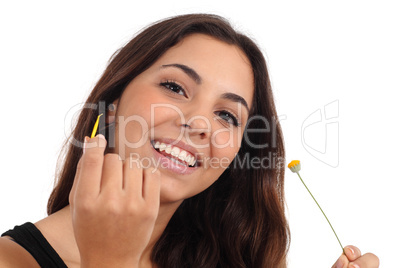 Teen girl defoliating a daisy smiling