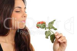 Teen girl smelling a flower