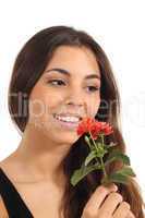 Teen girl smelling a flower