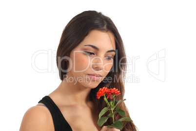 Teen girl smelling a flower