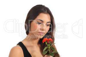 Teen girl smelling a flower