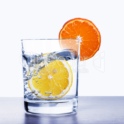 Glass of water with lemon and orange