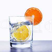 Glass of water with lemon and orange