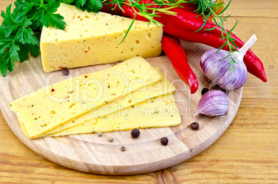 Cheese with spices and herbs on a round board