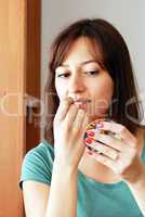 Young woman applying makeup