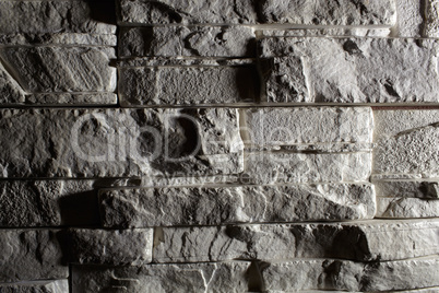 Gray brick background with shadows.