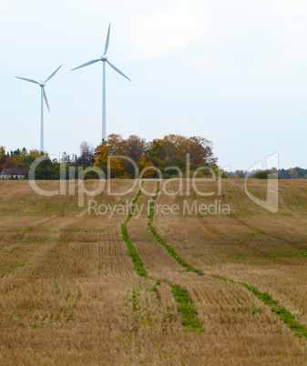 Two wind turbines in the field.