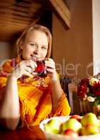 Young woman is drinking tea.