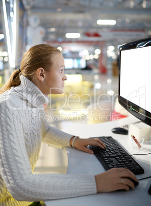 Young girl and blank monitor.
