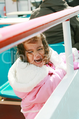playful pretty little girl excited recreating in a ride on sail