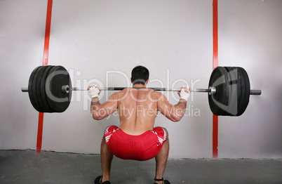 The concept of power and determination of a man lifting a weight