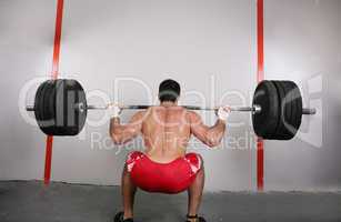 The concept of power and determination of a man lifting a weight