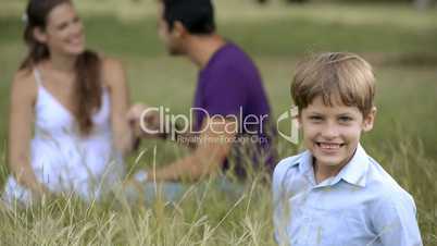 Happy family with son and parents playing at park