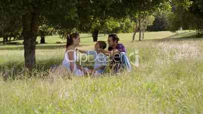 Family with happy young man, woman and child playing