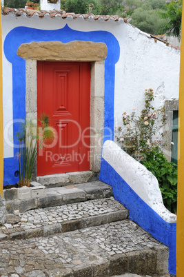 Portugal, a red door in the village of Obidos