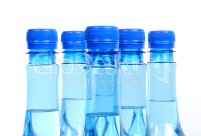 close up of gas water bottles on a white background