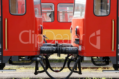 Railway carriages in the railway station. Symmetrical image. Train type is Bzmot without any trademark.