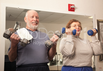 Senior Adult Couple Working Out in the Gym