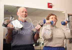 Senior Adult Couple Working Out in the Gym