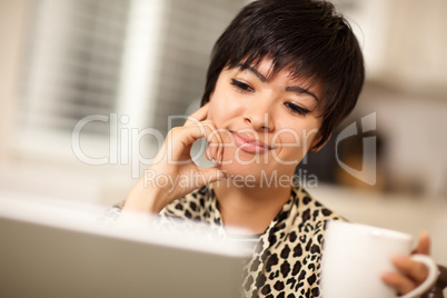 Pretty Smiling Mixed Race Woman Using Laptop