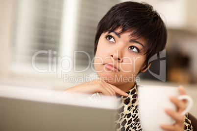 Pretty Mixed Race Woman Holding Cup Using Laptop