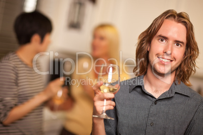 Smiling Young Man with Glass of Wine Socializing