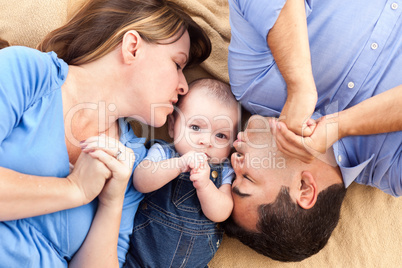 Mixed Race Family with Baby Playing on the Blanket