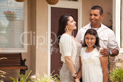 Small Happy Hispanic Family in Front of Their Home