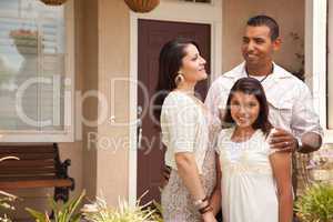 Small Happy Hispanic Family in Front of Their Home