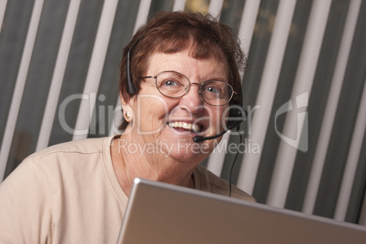 Smiling Senior Adult Woman with Telephone Headset and Monitor