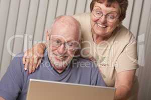 Smiling Senior Adult Couple Having Fun on the Computer