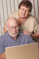 Smiling Senior Adult Couple Having Fun on the Computer