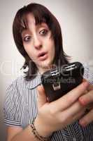 Stunned Brunette Woman Using Cell Phone