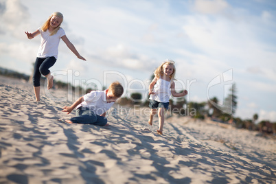 Adorable Brother and Sisters Having Fun at the Beach