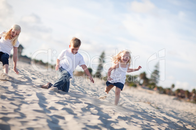Adorable Brother and Sisters Having Fun at the Beach