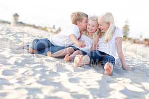 Adorable Sibling Children Kissing the Youngest